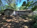 Rear view of the single-story home with a large window and a spacious backyard at 1420 Bethesda St, Apopka, FL 32703