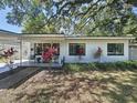 Inviting single-story home featuring a well-manicured lawn and a welcoming, covered front porch at 2114 Mount Vernon St, Orlando, FL 32803