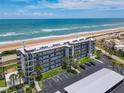 Coastal condos featuring ocean views, multiple balconies, covered parking, and well-maintained landscaping at 3100 Ocean Shore Blvd # 4030, Ormond Beach, FL 32176
