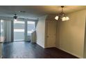 Bright living room features sleek flooring, a modern ceiling fan, and sliding doors for natural light at 3166 Riachuelo Ln, Kissimmee, FL 34744