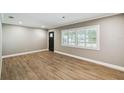 Bright living room showcases stylish wood-look flooring, neutral walls, and plantation shutters at 3520 N Westmoreland Dr, Orlando, FL 32804