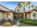Inviting front porch and walkway offer warmth and curb appeal to the home's entrance at 40137 County Road 452, Leesburg, FL 34788