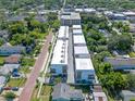 High angle shows the stylish townhomes surrounded by lush greenery and brick road at 42 W Harding St # E, Orlando, FL 32806