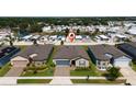 Aerial view of the neighborhood and home, near a pond with a pin marking the property at 426 Citrus Isle Loop, Davenport, FL 33837