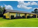 Side view of a one story home with a beautiful lawn and well maintained shrubbery at 4640 Chateau Rd, Orlando, FL 32808