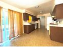 Traditional style kitchen with wood cabinetry and sliding glass door at 4640 Chateau Rd, Orlando, FL 32808