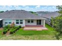 A covered back patio on a grassy area, perfect for outdoor living at 5215 Nw 34Th St, Ocala, FL 34482
