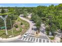 Aerial view of a quiet intersection in a lush green community with mature trees on a sunny day at 600 Garden Club Dr, Deland, FL 32724