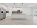 Modern kitchen featuring an island, stainless steel appliances, and white cabinets at 6139 Claystone Way, Mount Dora, FL 32757