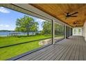 Screened-in porch with wood flooring and ceiling fans overlooking lake view at 633 Balmoral Rd, Winter Park, FL 32789