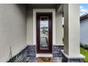 Inviting front door features decorative glass, and a 'Home Sweet Home' welcome mat at 7745 Somersworth Dr, Kissimmee, FL 34747