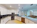 Modern kitchen features stainless steel appliances, sleek white cabinetry, and a stylish backsplash at 8851 Fallen Oak Dr, Davenport, FL 33896