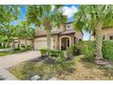 Beautiful home with a two-car garage, brick driveway, and a well-manicured lawn at 8989 Rhodes St, Kissimmee, FL 34747