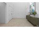 Bright foyer featuring tile floors, a console table, and an art piece enhancing the modern aesthetic at 14189 Larkspur Lake Dr, Winter Garden, FL 34787