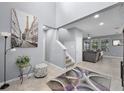 Bright foyer featuring high ceilings, tile flooring, staircase, and view to the living room at 1003 Nathan Ridge Rd, Clermont, FL 34715