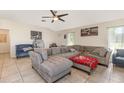 A spacious living room features tile floors, vaulted ceilings, and modern furniture at 10453 Old Studio Rd, Clermont, FL 34711
