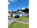 Traditional home boasts a well-manicured lawn and lovely landscaping for great curb appeal at 11714 Peachstone Ln, Orlando, FL 32821