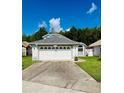 Well-maintained single-Gathering home with a 2-car garage and clean driveway at 11714 Peachstone Ln, Orlando, FL 32821