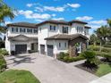 A beautiful home with a 3-car garage and a paver driveway, showcasing its architectural design and curb appeal at 14285 United Colonies Dr, Winter Garden, FL 34787