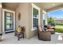 Inviting front porch with comfortable seating, perfect for relaxing and enjoying the neighborhood views at 14639 Winter Stay Dr, Winter Garden, FL 34787