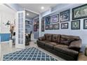 Cozy living room with comfortable leather seating and a charming adjacent office space at 14639 Winter Stay Dr, Winter Garden, FL 34787