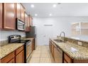 Modern kitchen featuring stainless steel appliances and granite countertops at 14706 Driftwater Dr, Winter Garden, FL 34787