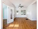 Spacious living room with sleek flooring, bright white walls, and natural light from multiple windows at 1511 New York Ave, St Cloud, FL 34769