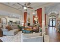 Inviting living room featuring an open floor plan, coffered ceilings, and rich wood flooring at 162 Seville Chase Dr, Winter Springs, FL 32708