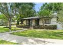 Charming single Gathering home showcasing lush landscaping, mature trees, and a welcoming front porch at 1701 Canton Street, Orlando, FL 32803