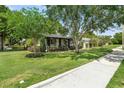Inviting single Gathering home with a lush green lawn, mature trees, and a charming exterior at 1701 Canton Street, Orlando, FL 32803