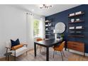Stylish office with a bold accent wall, custom shelving, and contemporary furnishings at 2291 Mossy Vine Ave, St Cloud, FL 34771