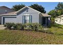 Lovely single story home with a neatly landscaped yard and gray paint, offering great curb appeal at 3055 Leflore Ln, Orlando, FL 32833