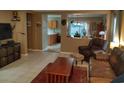 Inviting living room featuring tile floors, tan walls, and comfortable seating arrangement at 3055 Leflore Ln, Orlando, FL 32833