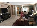 Inviting living room featuring tile floors, neutral walls, and an open flow into the kitchen at 3055 Leflore Ln, Orlando, FL 32833