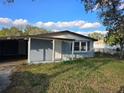 Charming single-story home with a covered carport, front door entry and landscaped yard at 306 W Palm St, Davenport, FL 33837