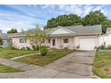 Cozy home with a well-maintained lawn and convenient driveway to the attached garage at 3162 Little Sound Dr, Orlando, FL 32827