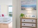 Hallway with a dresser, decorations, and a peek into a brightly lit living area at 322 E Central Blvd # 1612, Orlando, FL 32801