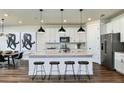 Modern kitchen featuring stainless steel appliances, a center island with bar stools, and ample cabinet space at 3406 Haven Side Rd, Davenport, FL 33837