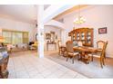 Elegant dining room with a chandelier, china cabinet, and plenty of natural light at 3843 Beacon Ridge Way, Clermont, FL 34711