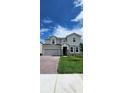 Beautiful two-story home with brick driveway, stone accents and manicured lawn at 4062 Serene Water Ave, Eustis, FL 32736