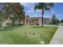 Inviting home boasts lush lawn, mature trees, and tidy landscaping at 420 Tulipwood Ln, Chuluota, FL 32766