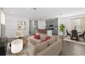 Bright open-concept living room with gray cabinets, stainless appliances and a dining nook at 502 Belmond Dr, Debary, FL 32713