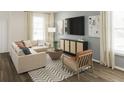 Inviting living room with neutral colors, stylish furniture and a modern media console at 502 Belmond Dr, Debary, FL 32713