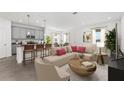 Open-concept living room and kitchen featuring a center island, gray cabinets and stainless appliances at 502 Belmond Dr, Debary, FL 32713