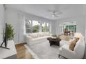 Bright living room with large windows, white sofa, accent chairs, and contemporary decor at 504 W Faith Ter, Maitland, FL 32751