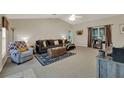 Spacious living room featuring neutral tones, plush sofa, and decorative rug at 626 Pearl Rd, Winter Springs, FL 32708
