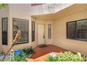 Entrance to the residence featuring a white door, red porch and beautifully landscaped surroundings at 7858 Sugar View Ct # 7858, Orlando, FL 32819