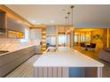 Stylish kitchen features a large island, stainless steel appliances, pendant lighting and sleek design at 8137 Pond Apple Dr, Winter Garden, FL 34787