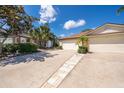 Charming home with an attached two-car garage, appealing landscaping, and a well-maintained walkway at 849 Millrace Pt, Longwood, FL 32750