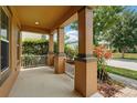Inviting front porch with classic columns and well-maintained landscaping at 9389 Meadow Hunt Way, Winter Garden, FL 34787